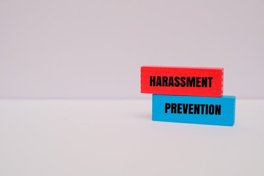 Colorful blocks with text "HARASSMENT PREVENTION". Corporate ethics, safety, and workplace policy concepts