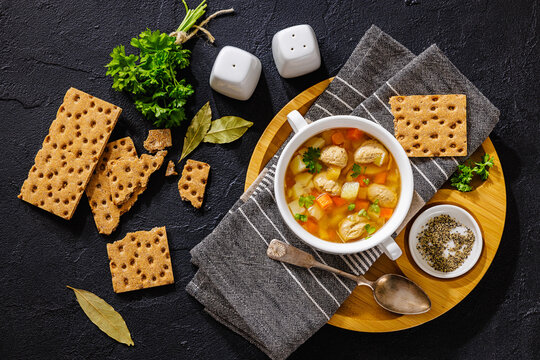 Old fashioned poultry meatball soup in clear broth