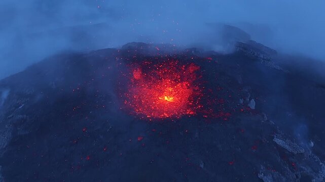 Aerial view of Volcan de Fuego erupting with glowing lava and volcanic ash in Yepocapa, Chimaltenango Department, Guatemala.