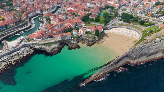 Aerial View of the Golden Sand Beach, Turquoise Ocean Water, and Sea Cliffs at Playa del Sabl&oacute;n Below Paseo de San Pedro in Llanes, Asturias, Northern Spain