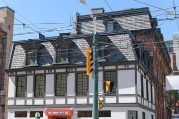 Fototapeta premium historic building facade and sign of The Carbon Snack Bar, a restaurant, located at 460 King St W, Toronto