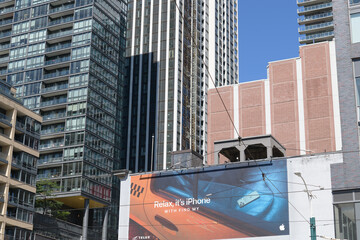 Fototapeta premium Apple Inc mural advertising at southeast corner of Spadina Av and King St W, Toronto (Find My feature)