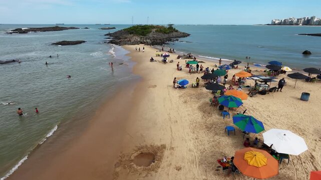 Drone 360 rotation shot of small peninsula revealing the coastline and skyline of Vila Velha Espirito Santo Brazil