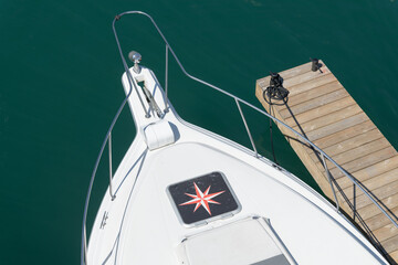 Fototapeta premium top-down detail of a boat with a nautical star patch and floating dock, Toronto
