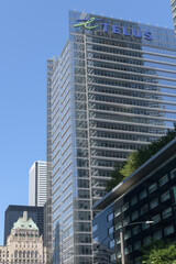 Fototapeta premium looking north on York St with view of TELUS Harbour building (25 York St, at Bremner) and view of historic Royal York hotel at Front St W, Toronto