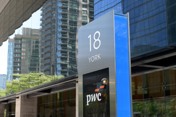 Fototapeta premium location marker and pylon sign at 18 York Street or PwC Building, Toronto