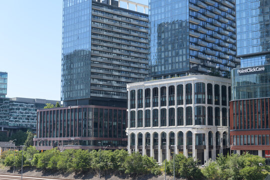 wide distant view of The Well (including sign of Sweat and Tonic, a fitness centre), terrace level, 486 Front St W, Toronto