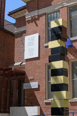Fototapeta premium exterior building facade and signage of Istituto Italiano di Cultura (Italian Cultural Institute) located at 496 Huron St, Toronto - also “Torre Gialla Nera” or Yellow Black Tower by Bruno Billio