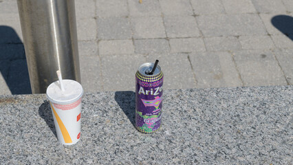 Fototapeta premium discarded beverage cup from McDonald's Canada and aluminum can of AriZona Grapeade, Toronto