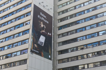 Fototapeta premium Apple Inc wall banner advertisement outside Senator David A Croll Apartments, 341 Bloor St W, Toronto