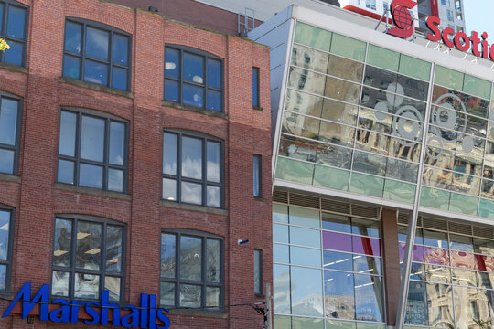 exterior building facades and signs of Marshalls, a department store chain (126 John St) and Scotiabank Theatre (259 Richmond St W), Toronto