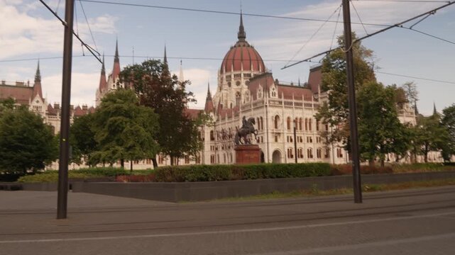 Cyclist passing the Parliament Budapest Hungary sunny summer day