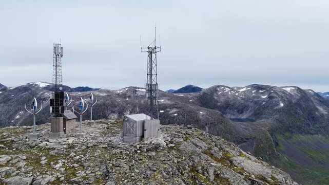 Aerial view of communication towers on the rocky summit of Trollstigen with mountainous terrain in the background in Andalsnes, More og Romsdal, Norway.
