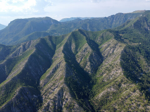 Aerial drone view of high mountains covered in forest. Mountain massif. Mountain range from an aerial perspective. Neretva river canyon, Bosnia and Herzegovina. 