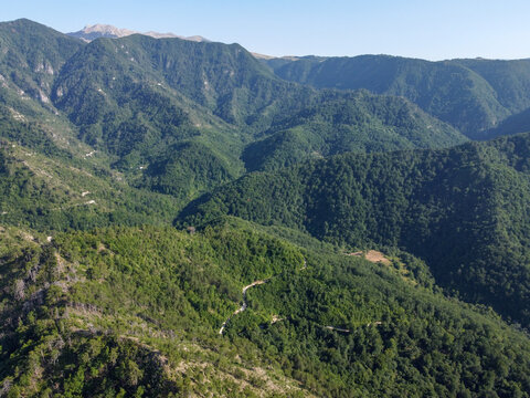 Aerial drone view of high mountains covered in forest. Mountain massif. Mountain range from an aerial perspective. Neretva river canyon, Bosnia and Herzegovina. 