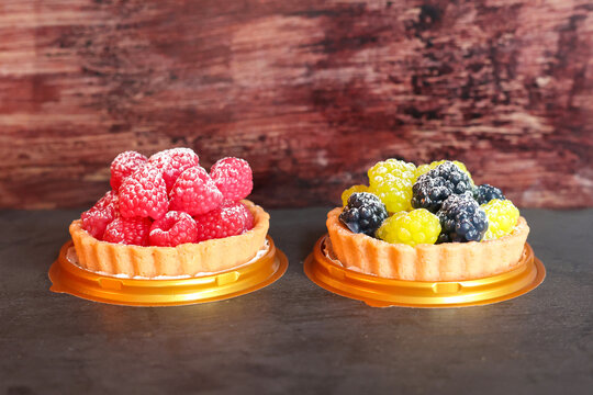 Delicate handmade soap raspberries carefully arranged in a gift box, realistic berry shapes crafted for beauty and skincare presents.