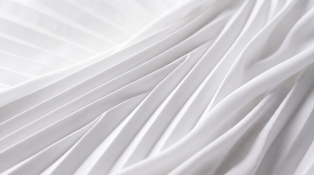 A close-up view of a white fabric with pleats, showcasing its textured and layered folds.