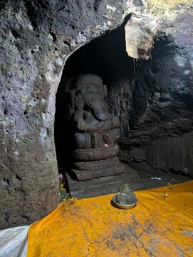 Ancient Ganesha stone statue inside Goa Gajah Elephant Cave temple in Ubud, Bali, Indonesia.