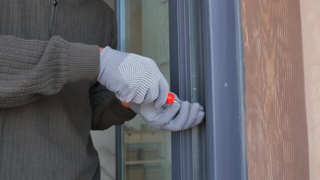 Handyman repairs door lock in residential area