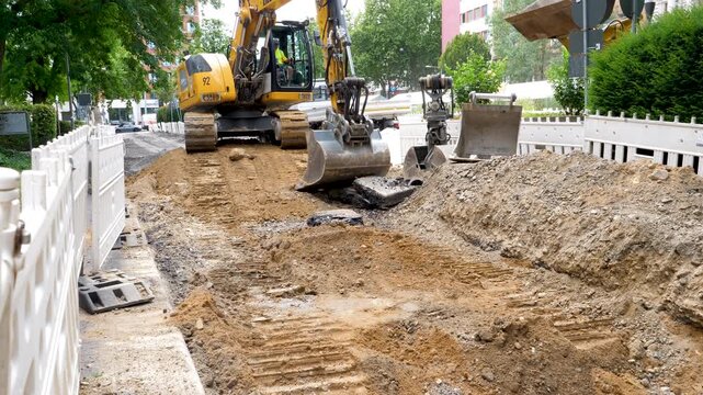 Wiesbaden, Germany - August 06, 2026: Installation of district heating lines in the city center of Wiesbaden. Large construction site, road works and bulldozer.