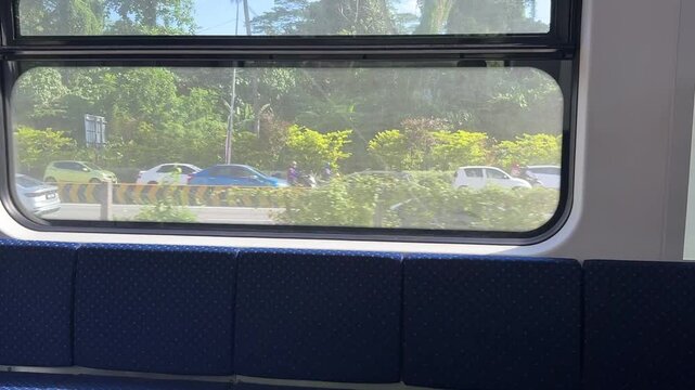 Malaysian KTM Komuter electric train arriving at the station platform, public transportation.