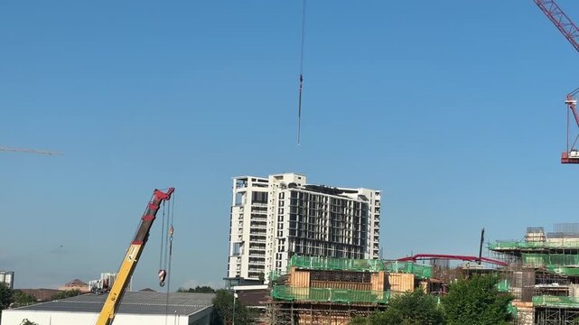 Close up of a massive industrial crawler crane operating at a bridge construction project.
