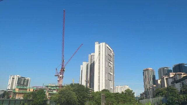 Close up of a massive industrial crawler crane operating at a bridge construction project.