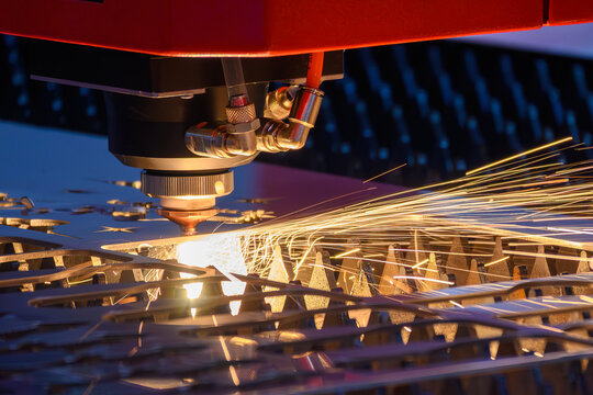 Sparkling light and sparks from fiber laser cutting machine engraving metal plate