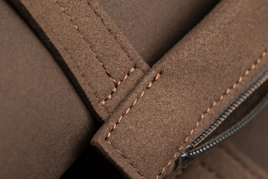 Brown nubuck leather texture with intricate stitching detail