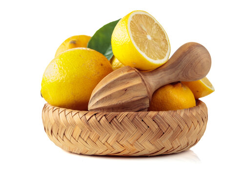 Fresh lemons and wooden juicer isolated on a white background.