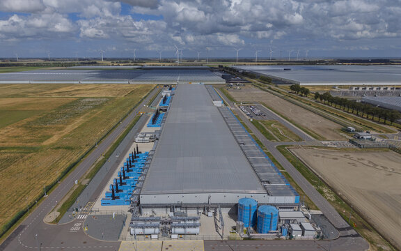 Aerial view of the Google data center at Agriport A7 surrounded by agricultural fields and wind turbines in Middenmeer, North Holland, Netherlands.