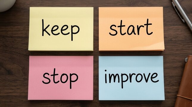 Business concept for gathering feedback in retrospective meeting using colorful sticky notes on a wooden desk.