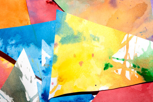 Triangle cut paper with paint splatters abstract rainbow background paint creative shapes