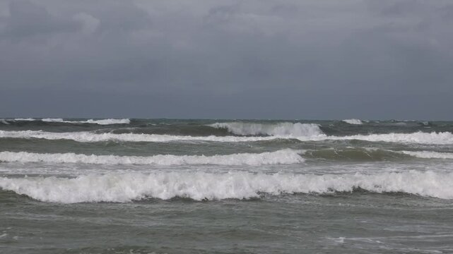 Hirtshals, Denmark A view of large waves on a windy day rolling into the beach.