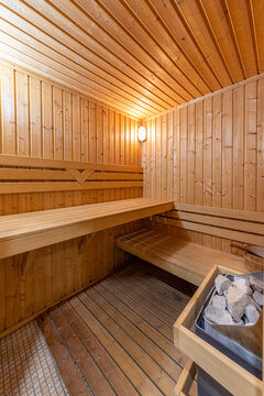 Cozy wooden sauna room interior. Traditional Finnish bath for relaxation, wellness, and spa therapy concept.