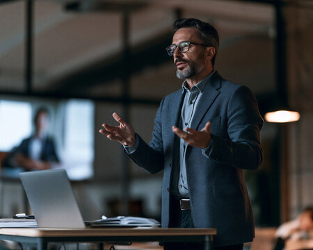 Experienced businessman actively presenting business strategy and sharing knowledge
