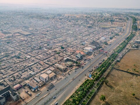 Aerial view of the dense urban landscape of Kawo featuring a major highway, residential buildings, and commercial structures in Kawo, Kaduna, Nigeria.