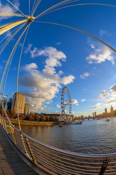 LONDON, ENGLAND - NOVEMBER 28, 2017: View with famous London Eye from Golden Jubilee bridges cross the River Thames. Sunset time.