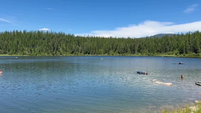Swimming, floating, canoeing, kayaking and paddle boarding on a Montana lake during the summer. 