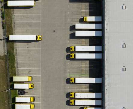 Aerial view of a DHL logistics facility with yellow trucks parked at loading bays in Zwolle, Overijssel, Netherlands.
