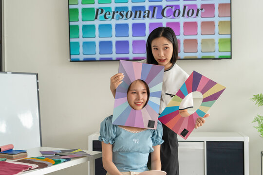 Stylist consulting client with color palettes in creative studio