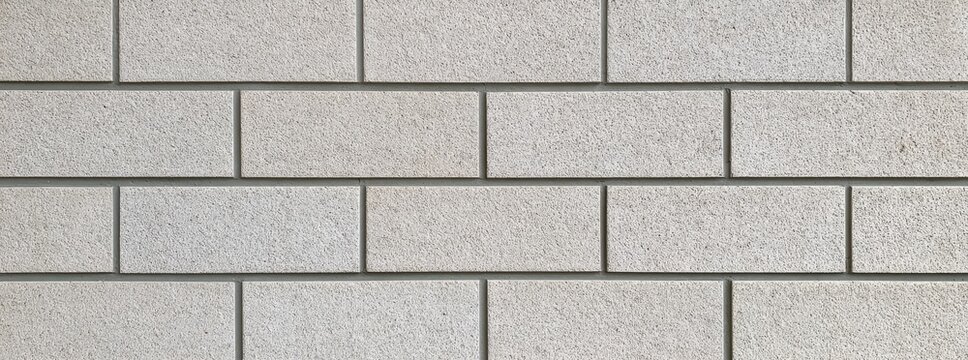 Seamless light beige brick wall texture background.