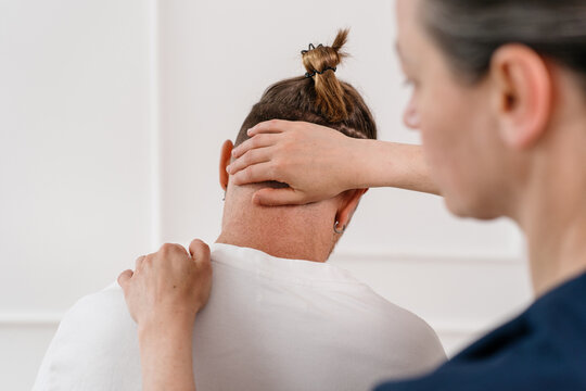 Physiotherapist provides treatment to patient during therapy session in clinic