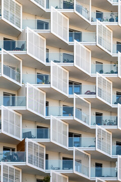 Seen at close range, white balconies project from an apartment facade, while repetition in the grid creates depth across Nordbahnviertel, Vienna, Austria.