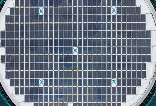 Aerial view of a circular floating solar power plant on the water surface in Liabygda, More og Romsdal, Norway.