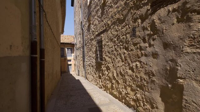 Narrow stone alley between historic buildings in the old town of Cuenca Castilla La Mancha
