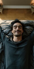 Fototapeta premium Relaxed man lying in bed with eyes closed and a slight smile for calm bedroom background and wellness poster use