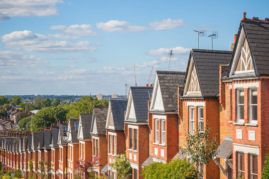 Row of English traditional terraced houses on hilly area in Crouch End, North London, UK