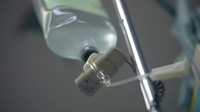 Close-up of intravenous fluid infusion equipment in a hospital, representing patient treatment, IV therapy, hydration, medical care, clinical procedures and healthcare support.