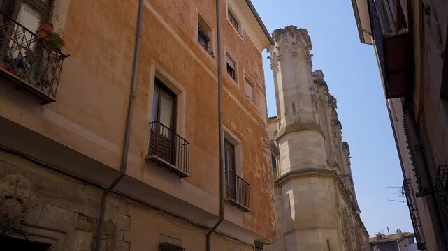 Narrow street beside Plaza Mayor with historic facades in the old town of Cuenca Spain